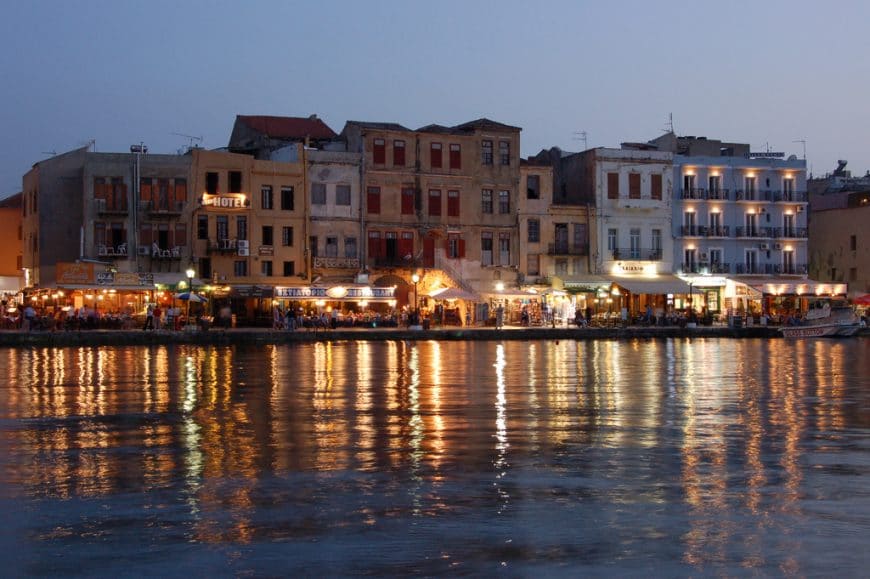 A stunning view of the Venetian harbour in Chania, Crete with colourful buildings and boats.